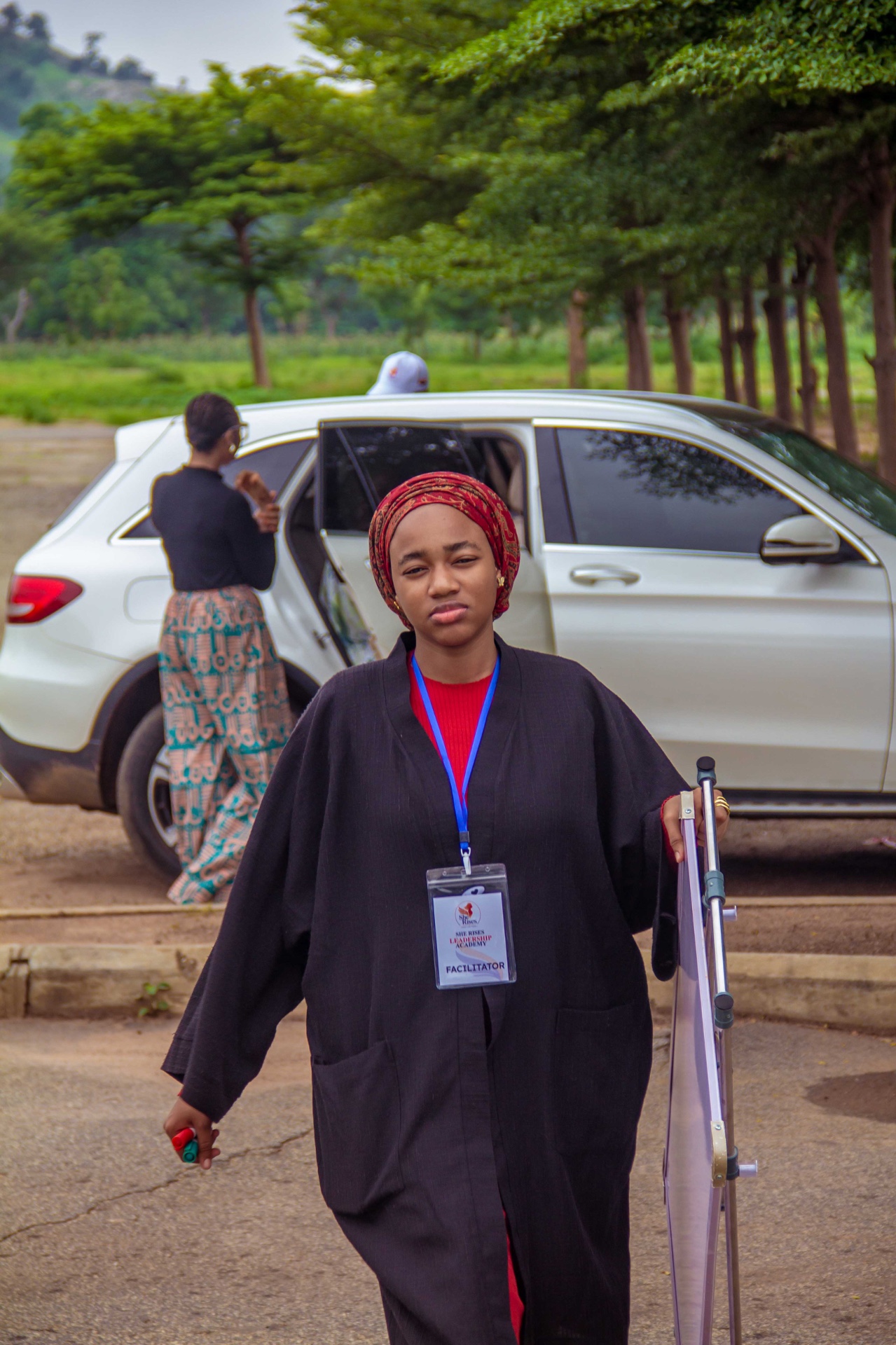 A She Rises Leadership Academy facilitator arriving on site