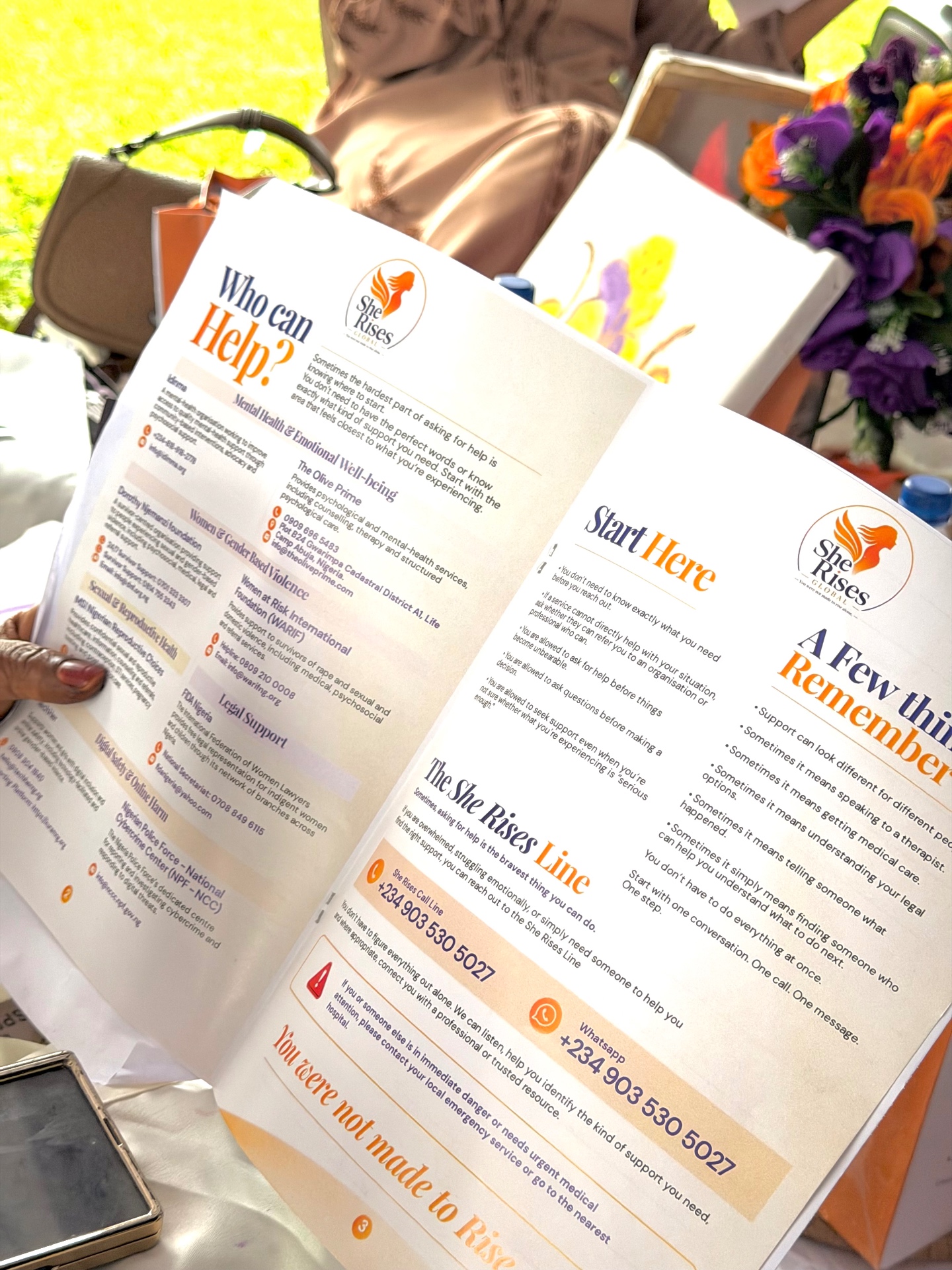 The She Rises resource brochure distributed to participants, listing helplines and support services